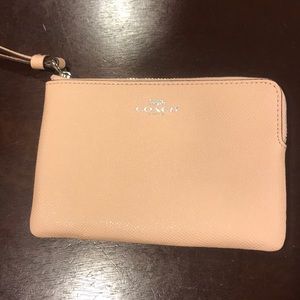 Brand new light pink coach wristlet.